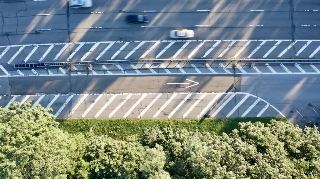 Des voitures qui roulent sur la route avec différents marquages au sol