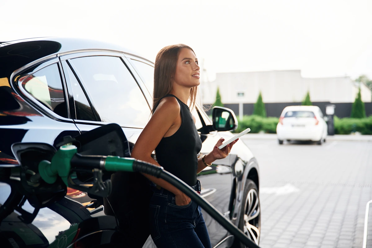 Une femme à la station service avec un SUV